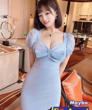 Local Chinese girl in light blue dress posing in luxury KL escort lounge