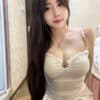 Emma wearing a white sheer sweetheart neckline dress offering girlfriend experience escort KL.