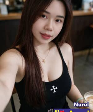 Friendly KL escort model with long dark hair posing for a portrait in Kuala Lumpur